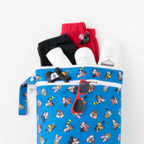 A Bumkins Wet Bag + Wet/Dry Bag Set: Mickey & Friends Forever packed with clothes, shoes, and sunglasses on a white background.